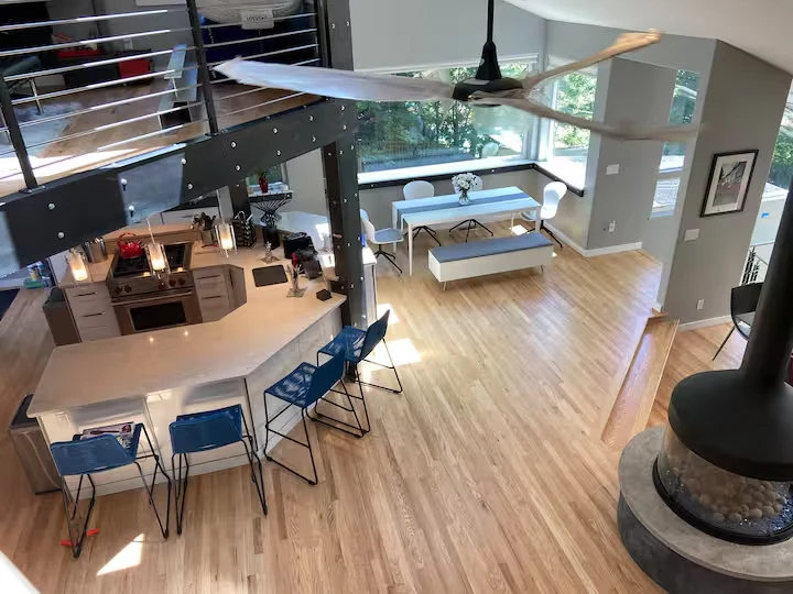 Overhead view of the kitchen breakfast bar, steel loft structure, hardwood floors and circular fireplace